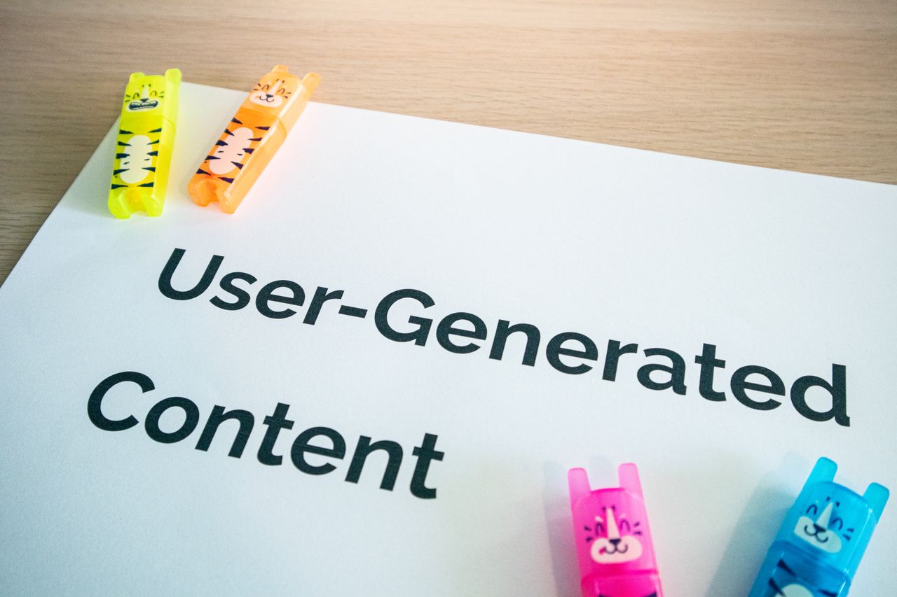 services-01 Bright highlighters on a User-Generated Content note against a wooden desk.